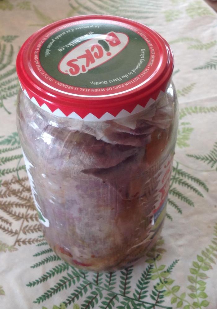 pickle jar stuffed with silk, rose petals and other dried flowers