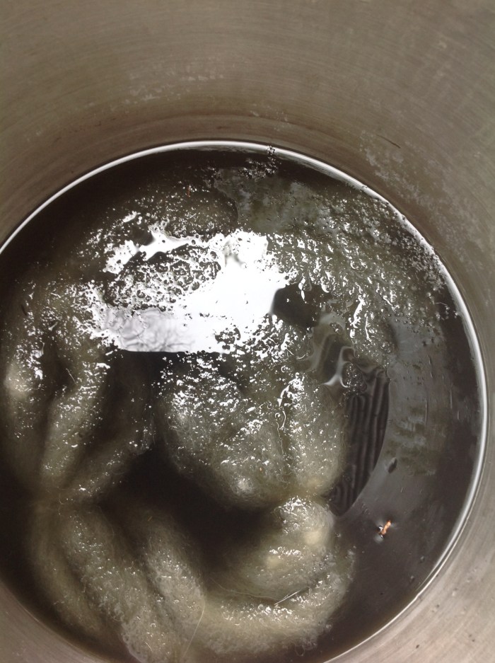 wool roving, treated with alum, in the dark Lily of the Valley dye